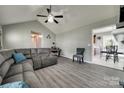 Open living room with vaulted ceiling, gray sofa, and tile flooring at 735 Shuttles Way, Fort Mill, SC 29715