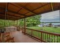 Covered porch with a porch swing, hot tub and beautiful views of the landscaped yard and lake at 7942 Vista View Dr, Sherrills Ford, NC 28673