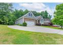 Landscaped home with a long driveway leading to a two-car garage and beautiful lawn at 968 Autumn Glen Ct, Clover, SC 29710