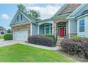 Inviting front entrance with a red door, stone accents, and well-maintained landscaping at 968 Autumn Glen Ct, Clover, SC 29710