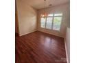 Well-lit dining room offers great natural light and hardwood floors at 978 Stinson Glen Ln, Charlotte, NC 28214