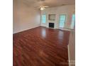Bright living area boasts wood floors, a fireplace, and seamless access to the kitchen at 978 Stinson Glen Ln, Charlotte, NC 28214