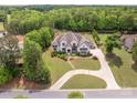 Expansive aerial view of home showcasing the well-manicured lawn, patio, and driveway at 1045 Spyglass Ln, Waxhaw, NC 28173
