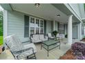 Relaxing front porch features comfortable seating and inviting outdoor decor at 13360 Old Compton Ct, Pineville, NC 28134