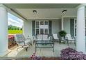 Spacious covered front porch with seating, perfect for enjoying the outdoors at 13360 Old Compton Ct, Pineville, NC 28134
