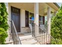 Inviting covered front porch with stone accents and decorative columns perfect for relaxing outdoors at 15431 Cimarron Hills Ln, Charlotte, NC 28278