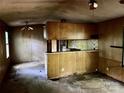 Living room featuring a breakfast bar and damaged walls at 163 Shanna Ln, Statesville, NC 28625