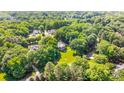 Expansive aerial view of the house and property highlighting the home's private, wooded setting at 1721 White Pond Ln, Waxhaw, NC 28173