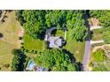 Aerial view of a private estate surrounded by lush greenery and mature trees at 1721 White Pond Ln, Waxhaw, NC 28173