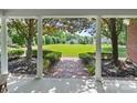 Exterior view of manicured lawn and landscaping from underneath the front porch at 1721 White Pond Ln, Waxhaw, NC 28173