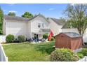 Well-maintained backyard featuring a patio, shed, and green grass at 18027 Train Station Dr, Cornelius, NC 28031