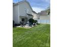 Spacious backyard featuring a patio, grill, and manicured lawn at 18027 Train Station Dr, Cornelius, NC 28031