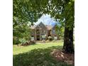 Beautiful brick home with manicured lawn and blue shutters and door at 19409 Laurel Glen Ave, Cornelius, NC 28031