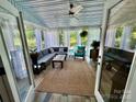 Relaxing sunroom with comfortable seating, ceiling fan, and outdoor views at 19409 Laurel Glen Ave, Cornelius, NC 28031