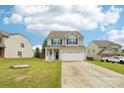 Charming two-story home with a two-car garage, landscaping, and front lawn at 217 Almora Loop, Mooresville, NC 28115