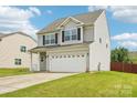 Charming two-story home with a two-car garage and well-maintained lawn at 217 Almora Loop, Mooresville, NC 28115