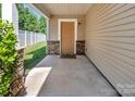 Covered porch with stone accent column and 'Hello' mat at 2751 Bramble Ridge Ct, Charlotte, NC 28215