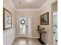 Bright foyer features hardwood floors, a decorative door, and elegant decor at 3333 Oliver Stanley Trl, Lancaster, SC 29720