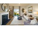 Cozy living room with fireplace and sliding glass doors to the backyard at 414 Janie Nw Cir, Newton, NC 28658