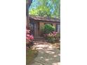 Inviting front porch with vibrant flowers and brick steps at 425 Roselawn Pl, Charlotte, NC 28211