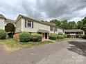 Well-kept townhouse exteriors with landscaped yards, brick details and off-street parking at 4609 Coronado Dr, Charlotte, NC 28212