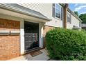 A charming front door with brick, manicured bushes, and an inviting doormat at 4609 Coronado Dr # N, Charlotte, NC 28212