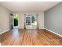 A living room featuring hardwood floors, neutral walls, and ample natural light at 4609 Coronado Dr # N, Charlotte, NC 28212