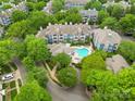 Aerial view of community featuring lush landscaping, swimming pool, and attractive blue siding at 611 Olmsted Park Pl # C, Charlotte, NC 28203