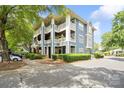 Exterior view of building with blue siding, white trim, and multiple balconies at 611 Olmsted Park Pl # C, Charlotte, NC 28203
