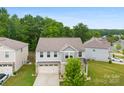 Aerial view of a two-story home, showcasing its neat landscaping, gray siding, and attached two-car garage at 614 Oldham Ln, Rock Hill, SC 29732