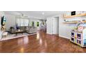 Open-concept living room with hardwood floors and neutral décor seamlessly connects to the kitchen at 619 Archibald Rd, Concord, NC 28025