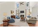 Elegant living room with high ceilings, a cozy fireplace, and large windows providing natural light at 7923 Mountain Shore Dr, Sherrills Ford, NC 28673