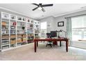 Spacious home office with built-in shelves, a large desk, and natural light at 9930 Karras Commons Way, Matthews, NC 28105