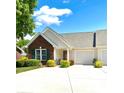 Inviting home with brick facade, a cozy front porch with seating, and a well-maintained lawn at 101 Keswick Ln, Mooresville, NC 28117