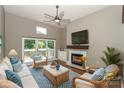 Cozy living room with a fireplace, ceiling fan, and comfortable seating arrangement at 104 Pier 33 Dr # 312, Mooresville, NC 28117