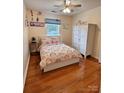 Bright bedroom with hardwood floors, ceiling fan, and ample storage space at 10408 Milstead Ct, Charlotte, NC 28215