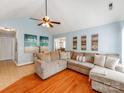 Bright living room with a large comfortable sectional sofa and an open view to the dining area at 10408 Milstead Ct, Charlotte, NC 28215