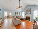 Spacious living room with vaulted ceilings, a cozy fireplace, and an open layout at 10408 Milstead Ct, Charlotte, NC 28215