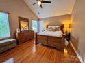 Spacious main bedroom featuring a vaulted ceiling, ceiling fan, and natural light at 10408 Milstead Ct, Charlotte, NC 28215
