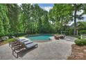Relaxing pool area with lounge chairs and outdoor seating, perfect for enjoying sunny days at 12028 Royal Lytham Ct, Charlotte, NC 28277