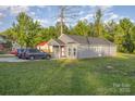 A charming gray home with a well-manicured lawn and driveway, surrounded by lush trees at 1263 Crawford Rd, Rock Hill, SC 29730