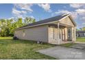 View of a single-story home with gray siding, a covered porch and a well-maintained lawn at 1263 Crawford Rd, Rock Hill, SC 29730