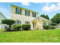 Inviting two-story home featuring a well-maintained lawn and inviting entrance at 12803 Matisse Ln, Charlotte, NC 28215
