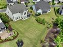 A spacious backyard with lush green grass, landscaping, trampoline, and a cozy fire pit area at 1287 Fishing Creek Rd, Lake Wylie, SC 29710