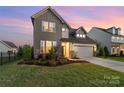 A beautiful two-story home with stone accents, a well-maintained lawn, and an attached two-car garage at 1287 Fishing Creek Rd, Lake Wylie, SC 29710