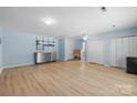 Well-lit basement featuring laminate flooring, neutral colored walls, shelving, and storage cabinets at 13914 Loch Loyal Dr, Charlotte, NC 28273