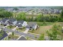 Expansive aerial view of a well-planned community with lush greenery and diverse home styles at 14218 Morningate St, Huntersville, NC 28078