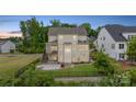 Spacious backyard with a stone patio, fire pit, and fenced yard, perfect for entertaining at 14218 Morningate St, Huntersville, NC 28078