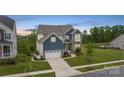 Beautiful two-story home with a manicured lawn, stone accents, and inviting curb appeal at 14218 Morningate St, Huntersville, NC 28078
