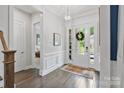 Inviting foyer with wood floors and a view into the living space at 14218 Morningate St, Huntersville, NC 28078